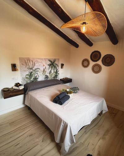 a bedroom with a large white bed with a fan at El Mirador de Mesones in Mesones de Isuela