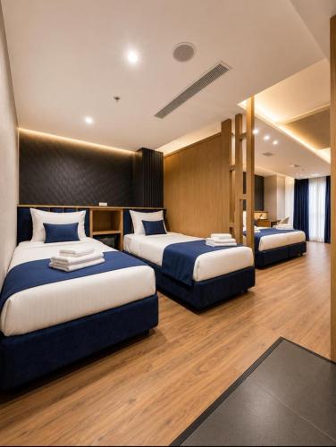 a hotel room with two beds in a room at The New Jai Son in Kobuleti