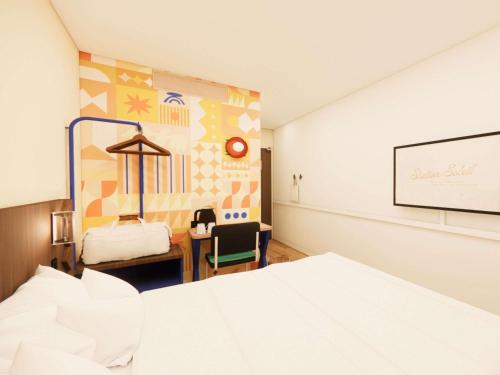a room with a white bed and a chalk board at ibis Styles Lyon Gerland in Lyon
