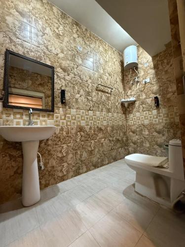 a bathroom with a sink and a mirror on the wall at Sariska Celebration Hotel & Resort in Alwar