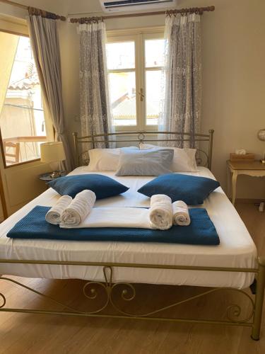 a bed with blue and white towels on it at Sweet Suite in Mytilene