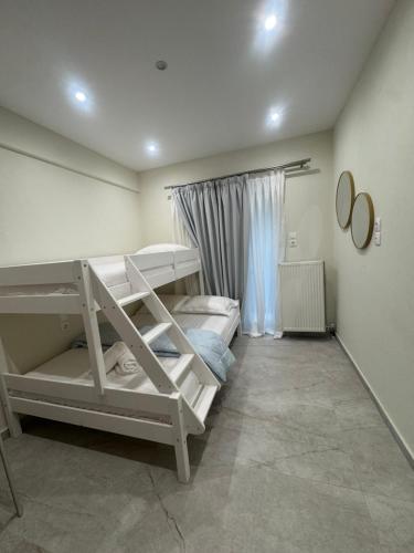 a room with two bunk beds and a window at Pramanta Nest in Pramanta