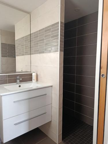 a bathroom with a white sink and a mirror at cabane féérique in Pléneuf-Val-André