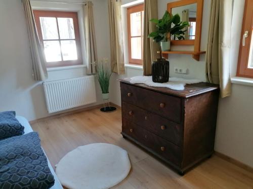 a bedroom with a dresser and a mirror at Ferienwohnung Mittergutnigg in Innervillgraten