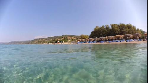 a beach with a bunch of chairs and the water at Casa Patronimio Aristotle Socrates Residence in Ierissos