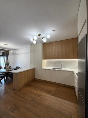 a kitchen with white cabinets and a dining table at Diktamo Village House in Ofrínion