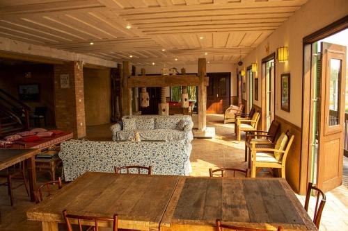 a living room with a wooden table and chairs at Pousada Engenho da Lagoa in Garopaba