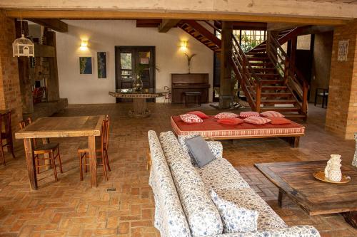 a living room with a couch and a table at Pousada Engenho da Lagoa in Garopaba