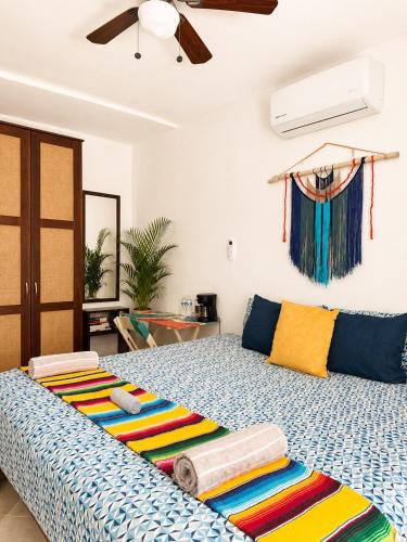 a bedroom with a large bed with towels on it at Garden House 2 bikes included in Mahahual