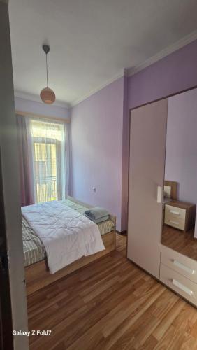 a bedroom with a bed and a window and a mirror at Cozy Townhouse in Yerevan