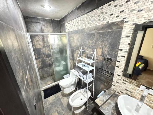 a bathroom with two toilets and a sink at Garden House 2 bikes included in Mahahual