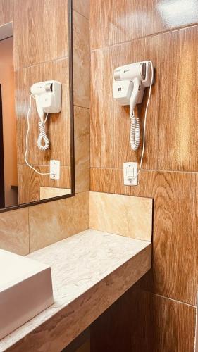 a bathroom with two cameras on the wall and a mirror at HOTEL IBIZA CUMBUCO in Cumbuco
