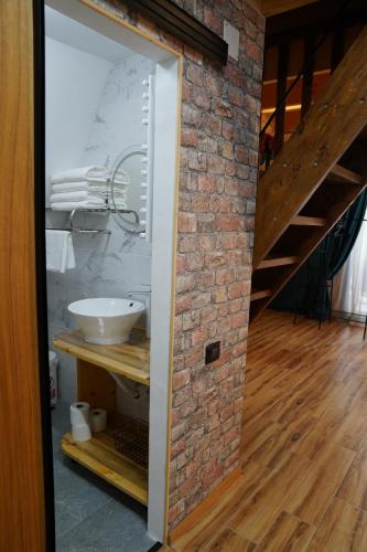 a brick wall and a staircase in a room at Andrei's Refugium in Ocnele Mari