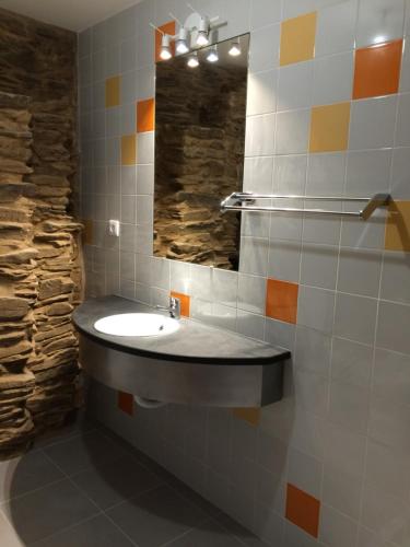 a bathroom with a sink and a mirror at Casas da Nascente in Loriga