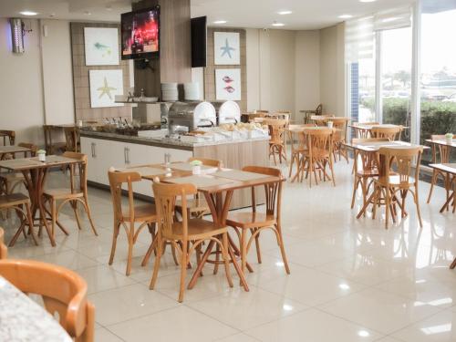 a dining room with wooden tables and chairs at Swan Rio Grande in Rio Grande