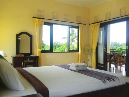 Postel nebo postele na pokoji v ubytování Wijaya Guest House Ubud