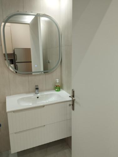 a bathroom with a sink and a mirror at Garden apartment G in Xanthi
