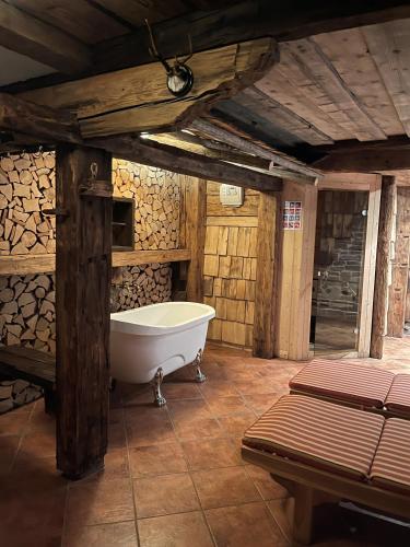 a bath tub in a room with wooden walls at Herbst Alm in Unken