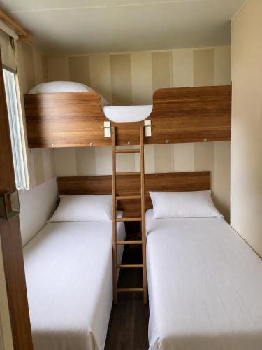 two bunk beds in a small room at Mobile-home in Ivry-la-Bataille