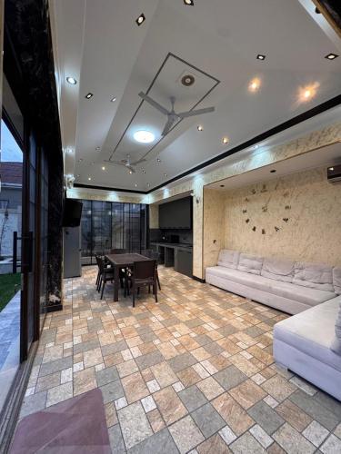 a living room with a table and a couch at Villa in Baku