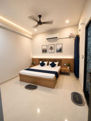 a bedroom with a bed and a ceiling fan at Hotel SunFort in Rājgīr