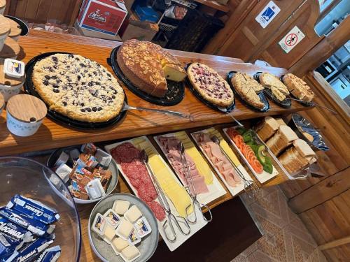 a bunch of different types of bread and pastries at Santa Maria Pucon in Pucón