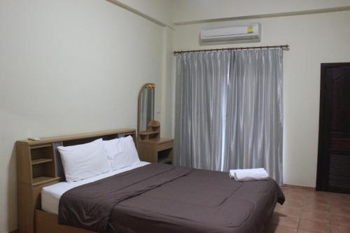 Ένα ή περισσότερα κρεβάτια σε δωμάτιο στο Lomsabai Apartments
