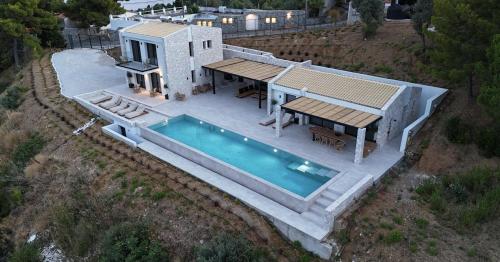 an aerial view of a house with a swimming pool at Villa Hillside Skiathos in Skiathos