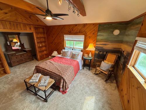 an overhead view of a bedroom with a bed and chairs at Mount Hope Bay Cottage in Fall River