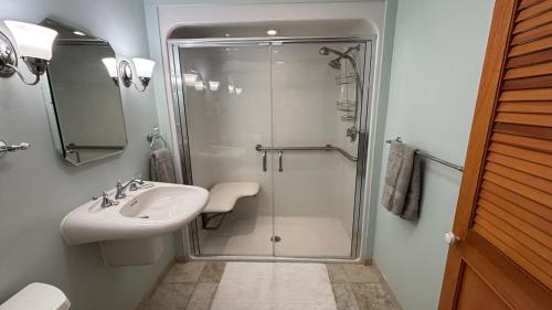a bathroom with a shower and a sink at Mount Hope Bay Cottage in Fall River