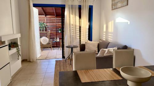 a living room with a couch and a table at Arithea Hidden Seaside Heritage 2BR Suite in Paphos