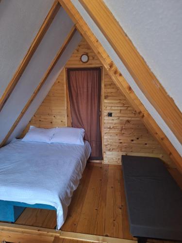 a bedroom with a bed in a attic at Koliba La Perla in Banja Luka