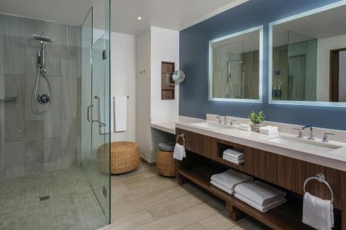 a bathroom with a sink and a glass shower at The Westin Los Cabos Resort Villas in San José del Cabo
