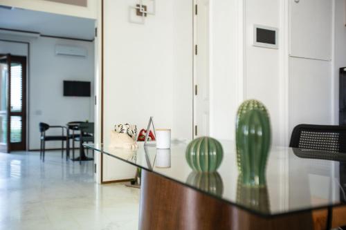 a glass table with a cactus on it in a room at Villa Sol Levante in Lequile
