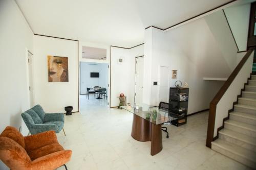 a living room with a glass table and chairs at Villa Sol Levante in Lequile