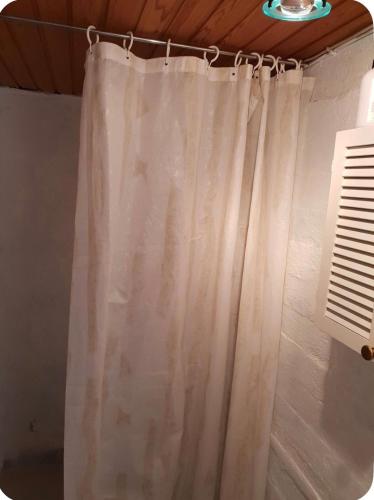 a shower curtain hanging from a rod in a bathroom at Central apartment in Vestmanna in Vestmanna