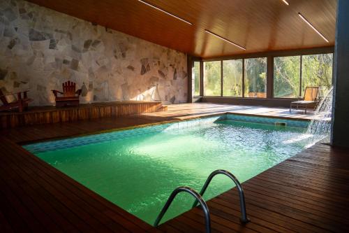 a swimming pool in a house with a large window at Grande Hotel Canela in Canela
