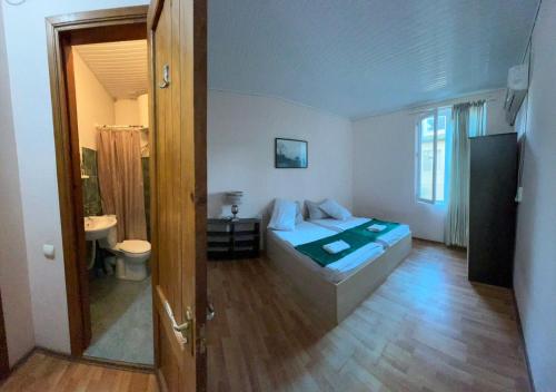 a bedroom with a bed and a bathroom at hotel shomari in Grigoleti