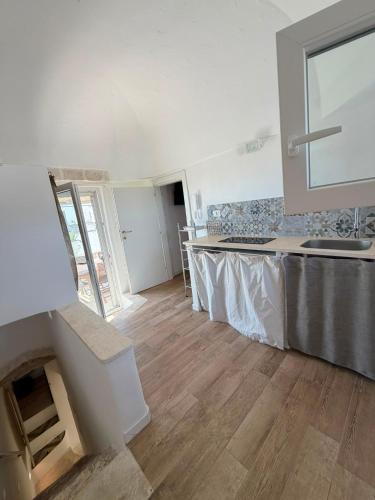 a kitchen with a sink and a counter top at Casa Ulivo in Ostuni