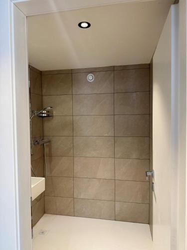 a shower with a glass door in a bathroom at Hotel & Restaurant Forni in Airolo