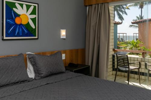 a bedroom with a bed and a balcony at El Aram Beach Cabo - All Inclusive in Cabo de Santo Agostinho