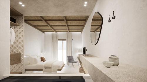 a white living room with a bed and a mirror at Malie Suites in Mikri Vigla