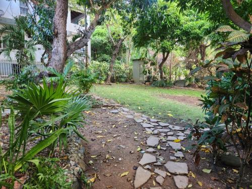 a garden with a stone walkway in a yard at Wilche Cottage in Road Town