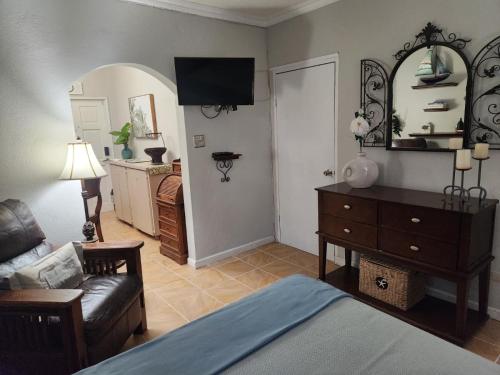 a living room with a bed and a couch and a television at Wilche Cottage in Road Town