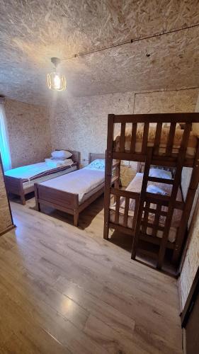 a room with two bunk beds and a lamp at Sarag in Ushguli