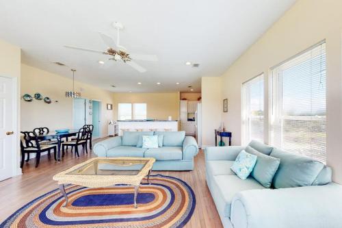 a living room with a couch and a table at Charming ocean-view gem with a pool deck washer dryer & central AC in St. George Island