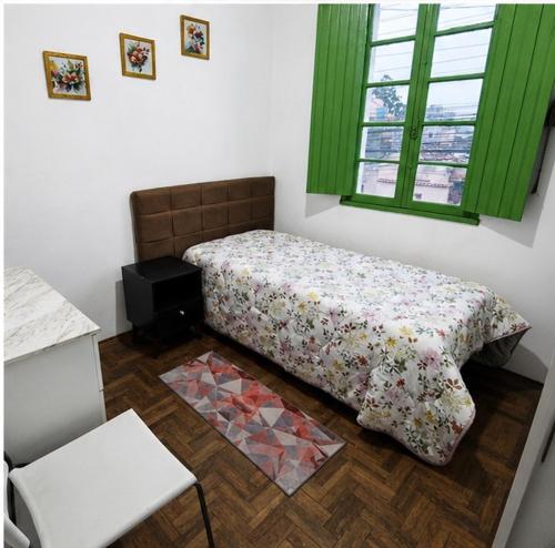 a small bedroom with a bed and a window at Sobrado de esquina in Pelotas