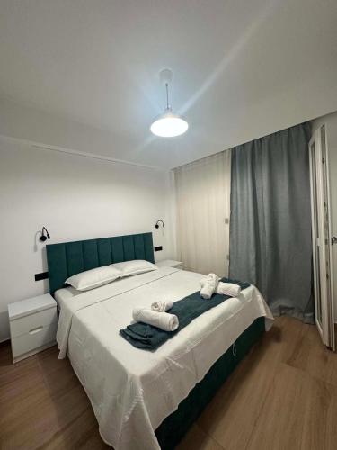 a bedroom with a large bed with towels on it at Aelio apartment in Ermoupoli