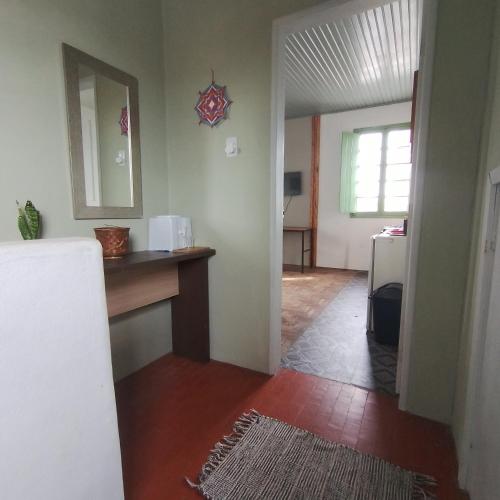 a room with a hallway with a counter and a refrigerator at Sobrado de esquina in Pelotas