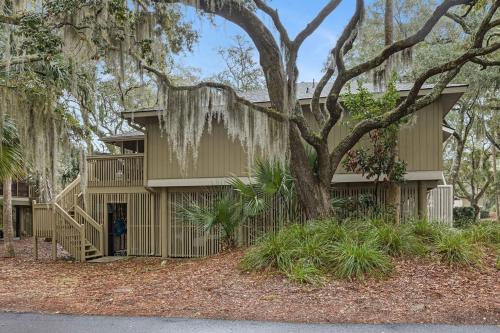 a house with a tree in front of it at 1128 Summerwind Cottage in Seabrook Island